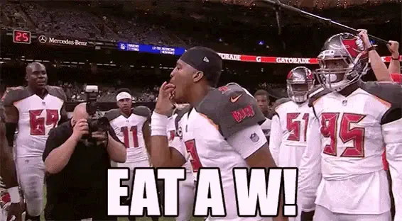 Jameis Winston eating a W in team huddle — getting hyped together to reinforce team culture